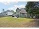 A house featuring a well-maintained lawn, patio, mature trees, and a backyard at 4185 Cami Way, Buford, GA 30519
