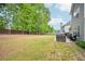 Beautiful backyard featuring well-maintained lawn, patio, and mature trees providing shade at 4185 Cami Way, Buford, GA 30519