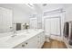 Bathroom with double sinks, large mirror, white cabinets, and a shower with shower curtain at 4185 Cami Way, Buford, GA 30519