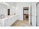 Bright bathroom features double vanity, large mirror, and an open doorway to the bedroom at 4185 Cami Way, Buford, GA 30519