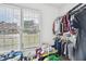 Walk-in closet with clothing racks, built-in shelves, and natural light from the window at 4185 Cami Way, Buford, GA 30519