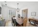 Formal dining room with hardwood floors, modern chandelier, and windows with shutter blinds at 4185 Cami Way, Buford, GA 30519