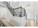 Bright foyer with hardwood floors, an elegant staircase, and a view of the front entrance for a grand welcome at 4185 Cami Way, Buford, GA 30519