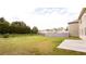 Expansive backyard featuring a large grassy area and mature trees at the back of the property at 7747 Rudder Cir, Fairburn, GA 30213