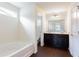 Well-lit bathroom with double vanity and soaking tub at 7747 Rudder Cir, Fairburn, GA 30213