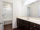 Bathroom with a dark wood vanity and mirror at 7747 Rudder Cir, Fairburn, GA 30213