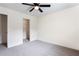 Bedroom with ceiling fan, plush carpeting, and access to a closet at 7747 Rudder Cir, Fairburn, GA 30213