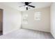 Bedroom with plush carpeting, ceiling fan, and lots of natural light at 7747 Rudder Cir, Fairburn, GA 30213