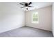 Cozy bedroom features plush carpet, neutral walls, and a ceiling fan at 7747 Rudder Cir, Fairburn, GA 30213