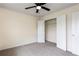 Bedroom with plush carpeting, ceiling fan, and access to closet at 7747 Rudder Cir, Fairburn, GA 30213