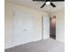 Bedroom with plush carpeting, ceiling fan, and double closet at 7747 Rudder Cir, Fairburn, GA 30213