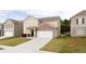 Attractive home with a brick-accented facade and a spacious driveway leading to a two-car garage at 7747 Rudder Cir, Fairburn, GA 30213