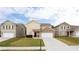 Inviting two-story home featuring a well-manicured lawn and attached two-car garage at 7747 Rudder Cir, Fairburn, GA 30213
