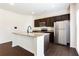 Modern kitchen features granite counters, stainless steel appliances, and dark wood cabinets at 7747 Rudder Cir, Fairburn, GA 30213