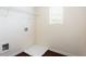 Bright laundry area featuring a wire shelf, hookups, and natural light from the window at 7747 Rudder Cir, Fairburn, GA 30213