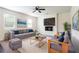 Inviting living area with comfortable seating, a mounted TV, and a cozy fireplace at 7747 Rudder Cir, Fairburn, GA 30213