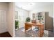 Bright home office with a wooden desk, shelving unit, and natural light from a window at 7747 Rudder Cir, Fairburn, GA 30213