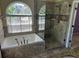 Bathroom with a soaking tub, separate glass shower, large window, and tile at 2435 Jakin Way, Suwanee, GA 30024