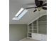 Bright bonus room featuring built-in shelves and a skylight, perfect for a home office or playroom at 2435 Jakin Way, Suwanee, GA 30024