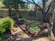 Landscaped garden area with a variety of plants, decorative pots, and a gravel path at 2435 Jakin Way, Suwanee, GA 30024