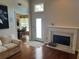 Bright living room with fireplace and access to the dining area, perfect for entertaining at 2435 Jakin Way, Suwanee, GA 30024