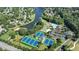 Aerial view showcases tennis courts, community pool, lake, playground, and surrounding neighborhood at 3500 Millwater Xing, Dacula, GA 30019