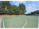Outdoor community basketball court next to playground on well-maintained grounds, surrounded by trees at 3500 Millwater Xing, Dacula, GA 30019