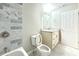 Bathroom with white marble floors, updated fixtures, and tile shower at 3500 Millwater Xing, Dacula, GA 30019
