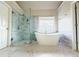 Modern bathroom featuring a glass enclosed shower and a soaking tub at 3500 Millwater Xing, Dacula, GA 30019