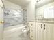 Bathroom featuring marble tiled walls around the tub/shower combination and vanity at 3500 Millwater Xing, Dacula, GA 30019