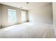Spacious bedroom with plush carpeting, offering abundant natural light from dual windows at 3500 Millwater Xing, Dacula, GA 30019