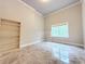 Cozy bedroom featuring crown molding, a window, and an open closet system at 3500 Millwater Xing, Dacula, GA 30019