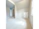 A well-lit bedroom with neutral carpeting and paint, offering a view of the hallway and a glimpse into the closet at 3500 Millwater Xing, Dacula, GA 30019