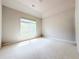 Bright bedroom features neutral walls, large window, and plush carpeting at 3500 Millwater Xing, Dacula, GA 30019