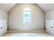 Bright bedroom featuring a large window and neutral carpeting, with access doors for storage at 3500 Millwater Xing, Dacula, GA 30019