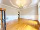 Elegant dining room with hardwood floors, classic chandelier, and detailed trim work at 3500 Millwater Xing, Dacula, GA 30019