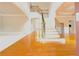 Grand foyer with hardwood floors, a staircase with wrought iron railings, and ample natural light at 3500 Millwater Xing, Dacula, GA 30019