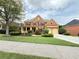 Charming two-story brick home featuring an inviting front porch, manicured lawn, and a two-car garage at 3500 Millwater Xing, Dacula, GA 30019