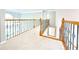 A brightly lit hallway with a beautiful wood and iron railing at 3500 Millwater Xing, Dacula, GA 30019