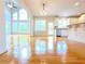 Open concept kitchen with white cabinetry, stainless appliances, and hardwood flooring at 3500 Millwater Xing, Dacula, GA 30019