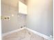 This is a laundry room with white marble floors and white cabinets offering storage space at 3500 Millwater Xing, Dacula, GA 30019