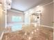 Open concept living area with gorgeous stone floors, large windows and high ceilings at 3500 Millwater Xing, Dacula, GA 30019