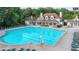 Community pool with lounge chairs and a lifeguard stand, surrounded by well-maintained landscaping at 3500 Millwater Xing, Dacula, GA 30019