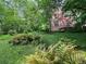 Lush backyard with ferns and view of the home at 4705 Paran Nw Vly, Atlanta, GA 30327