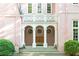 Elegant entrance with white columns, arched windows, decorative railing, and meticulously manicured landscaping at 4705 Paran Nw Vly, Atlanta, GA 30327