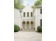 Elegant exterior of a home featuring a stone facade, symmetrical windows, and a columned balcony with decorative circular windows at 4705 Paran Nw Vly, Atlanta, GA 30327