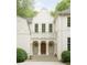 Elegant facade with detailed stonework, arched door, and symmetrical windows at 4705 Paran Nw Vly, Atlanta, GA 30327