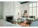Comfortable living room with a fireplace, floral armchairs, and a glass coffee table at 4705 Paran Nw Vly, Atlanta, GA 30327