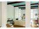 Bright living room featuring wood floors, columns, a fireplace, and a unique light blue ceiling at 4705 Paran Nw Vly, Atlanta, GA 30327