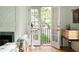 Bright living room featuring a decorative fireplace, stylish furnishings, and French doors to the outside at 4705 Paran Nw Vly, Atlanta, GA 30327